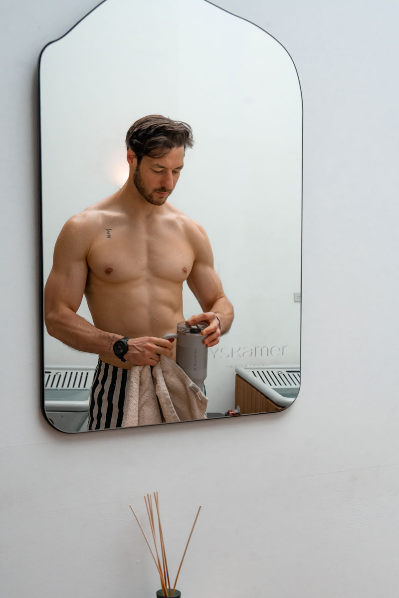 The coach is posing while looking at the mirror.